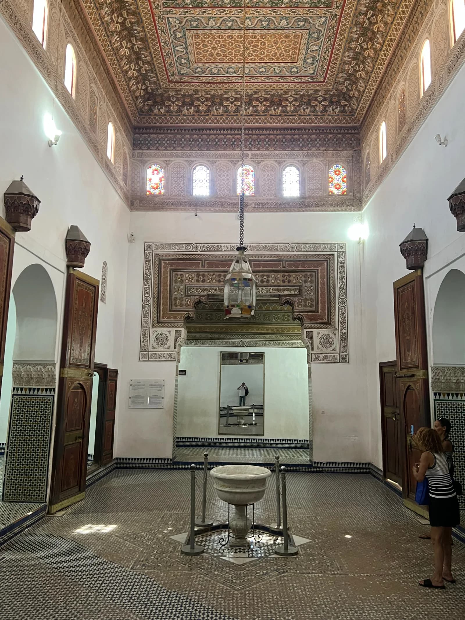 Grand reception hall with painted ceiling and central fountain at Bahia Palace